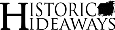 Logo for Historic Hideaways with name in print and a shadow image of a cottage and palm tree.