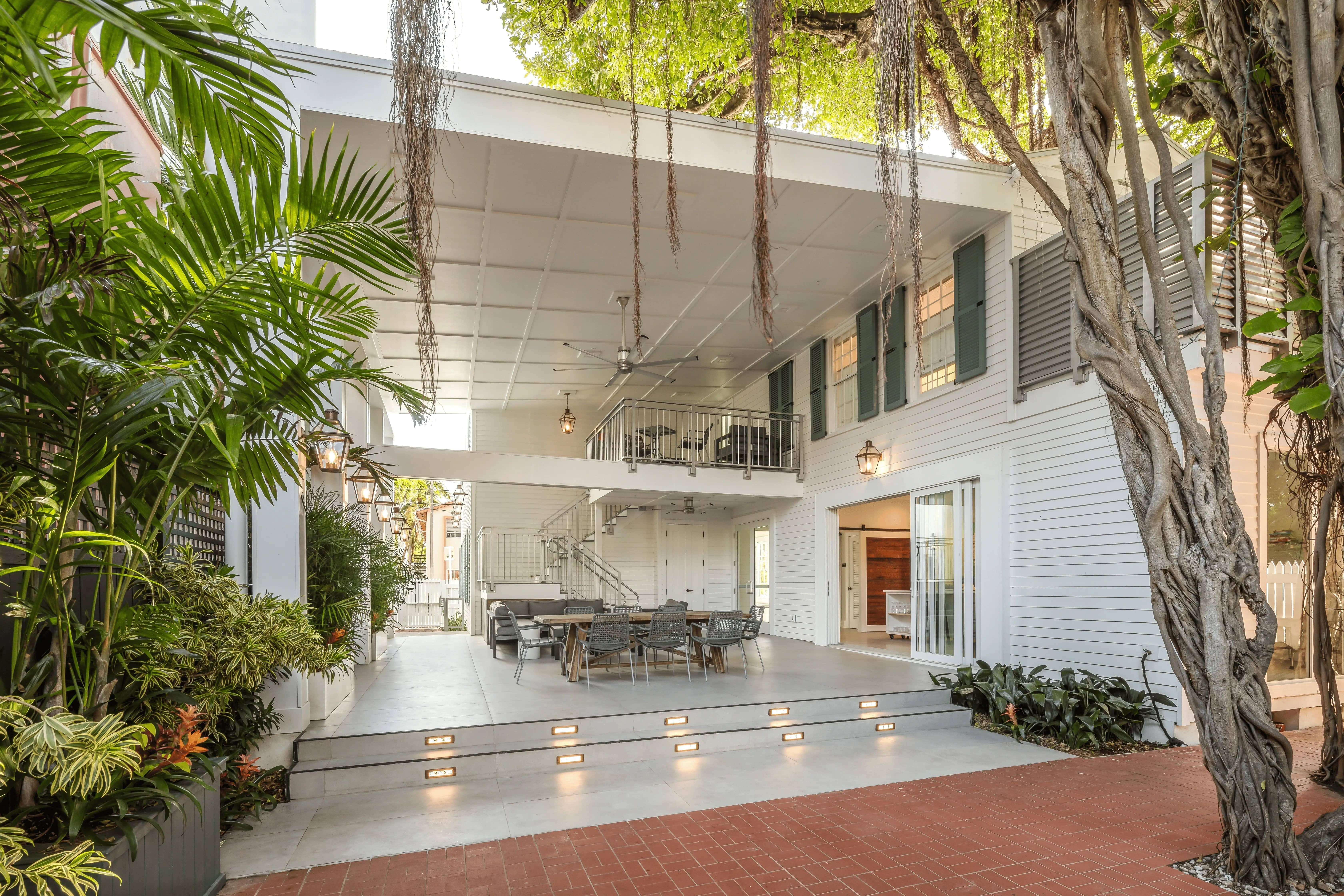 Image of PEAR House with open balcony and trees around.