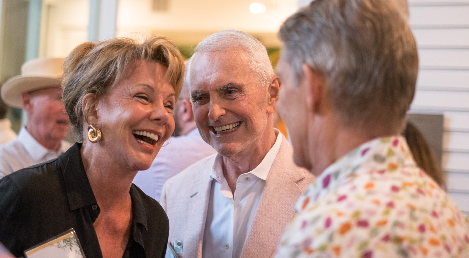 Guests smile and talk during a gathering at The Studios of Key West.