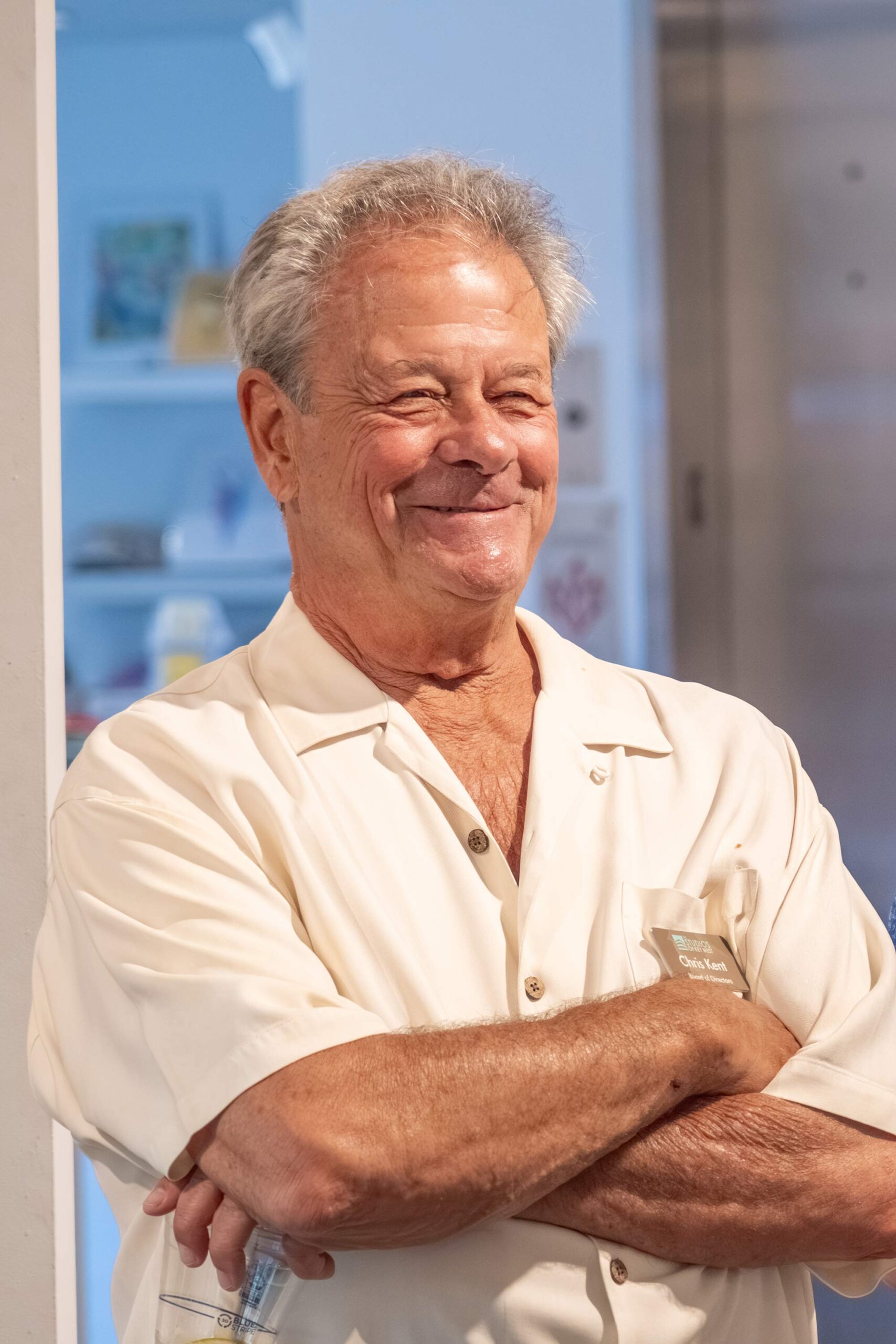 Chris Kent smiling with his arms crossed at an event at The Studios of Key West.