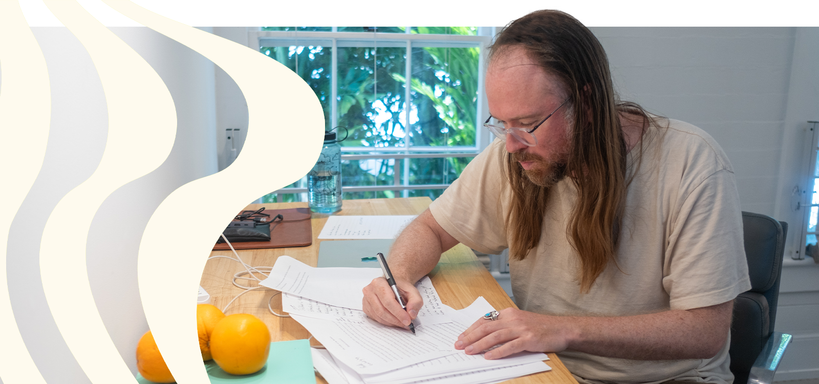 Writer Maxim Loskutoff works on a manuscript at a table during his residency in Key West.