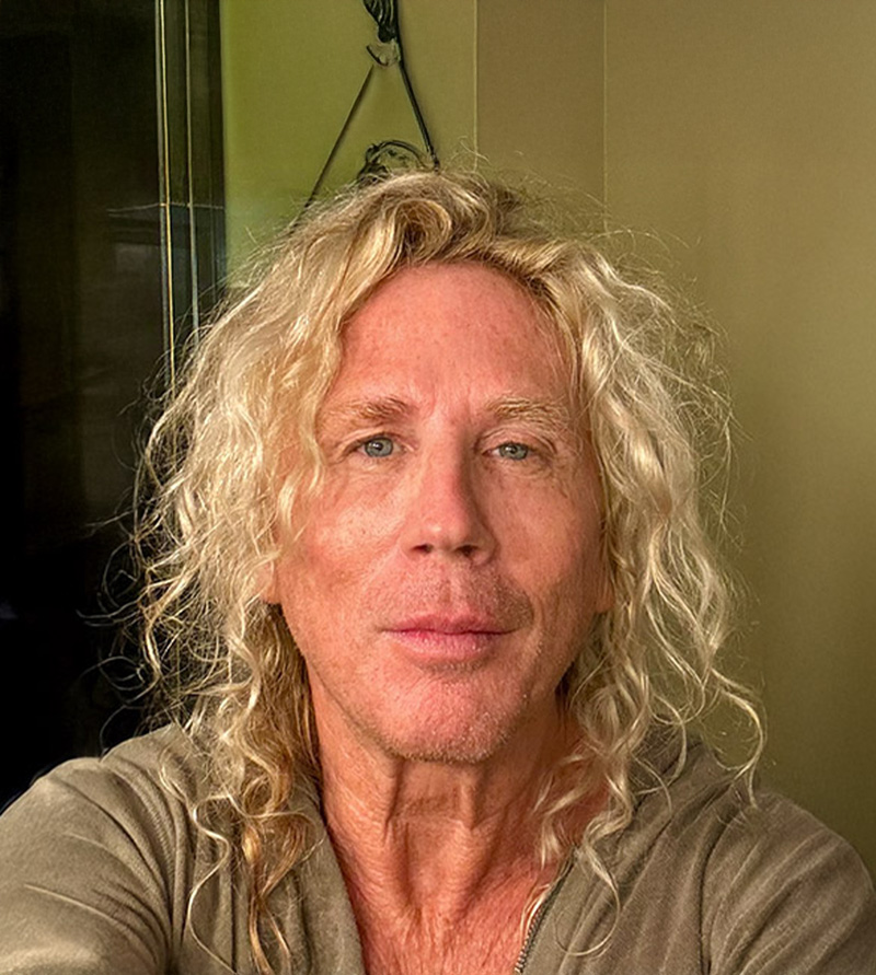 Scott King in a close-up portrait with long, wavy blond hair.