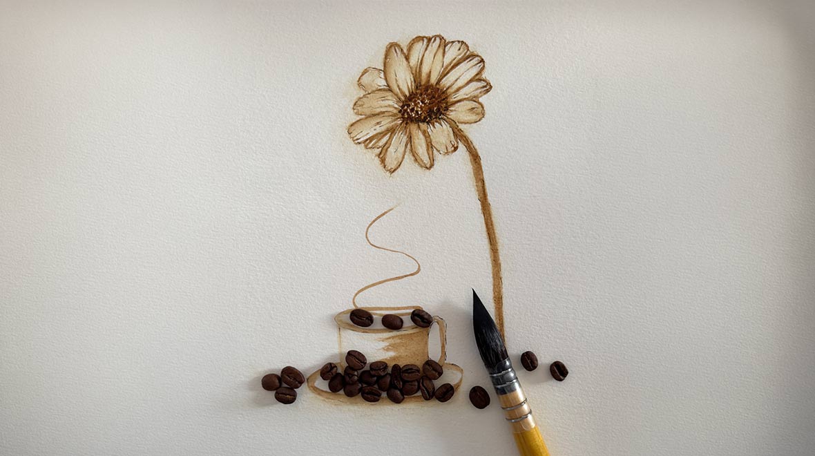 Sepia-toned painting of a daisy growing from a coffee cup, surrounded by coffee beans and a paintbrush on white paper.